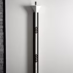 a white clock is against a grey brick wall