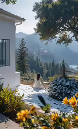 woman sitting on a patio area with mountains in the background