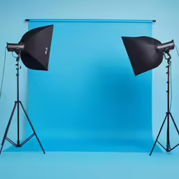 two umbrellas sitting next to each other on top of a blue background