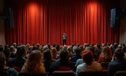 a person standing on a stage in front of an audience