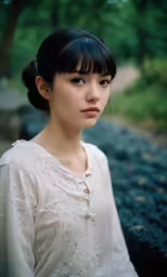 a girl in white with bangs and an eye ring