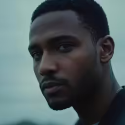 the man looks away from the camera while staring