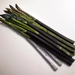 an assortment of black and green vegetables are lying on the table