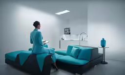 woman sitting on top of a couch next to a couch