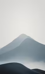 the top of a mountain covered in fog and mist