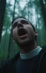 a man standing in the woods with a mouth open
