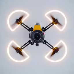 a small yellow flying with two cameras