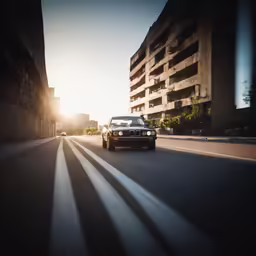 a vehicle driving down the street in a city