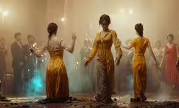 three women are dancing in a group of people