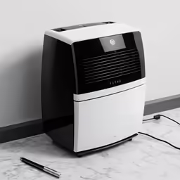a black and white desktop pc next to a gray wall
