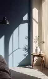 a sunlit bedroom with a plant and side table