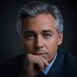 a man is staring at the camera with grey hair