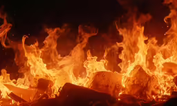 a large fire blazing over a black background