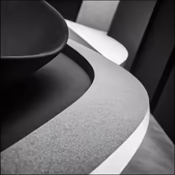 a room with several chairs and one has a black seat