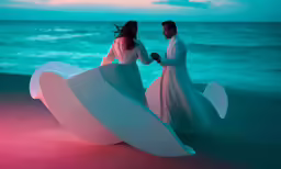 two people holding hands standing in front of a giant piece of paper