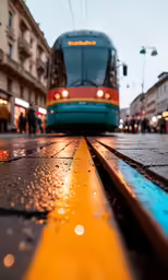 a blue bus that is on some wet pavement