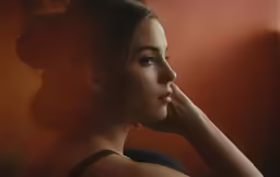 a woman looks out the window at something