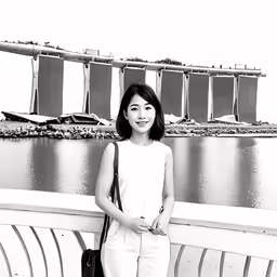 young girl in white posing at the edge of a bridge