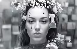 a woman with flowers on her head in the rain