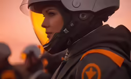 a girl in black and orange wearing helmet