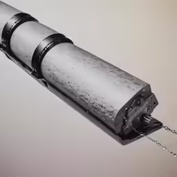 a metal object on a chain suspended in the air