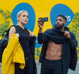 the man is taking a selfie with his camera while he holds a phone