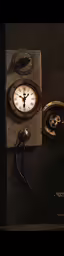 a clock with a metal lever sitting next to it