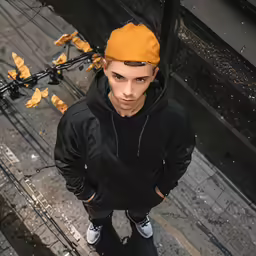 an overhead view of a male in black hooded sweatshirt