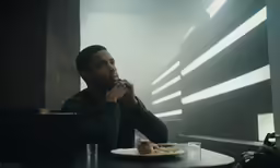 a man sitting at a table with food
