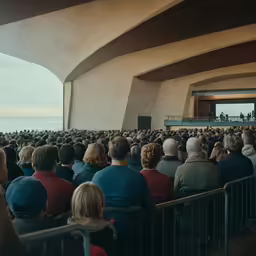 large group of people sitting at large outdoor event