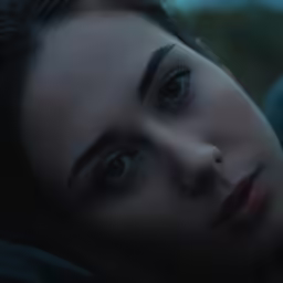 the woman is staring forward with her eyes close