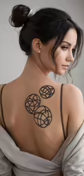 woman with geometric tattoos showing back of neck