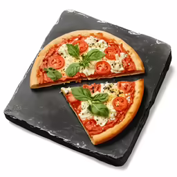 a pizza on a slate platter with a slice cut
