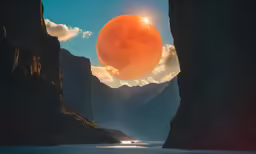 a very large orange ball rising above the water