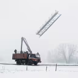 a utility truck with workers in the background