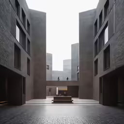 a courtyard with some buildings in the background