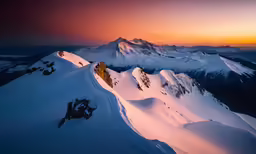 a snowy mountain peak with some very big mountains