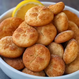 the bowl has fried little sandwiches in it