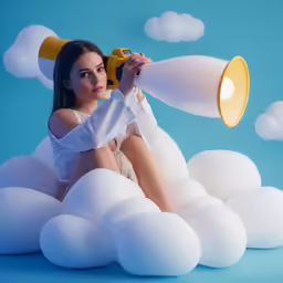 a woman holding a gold record sitting in the clouds