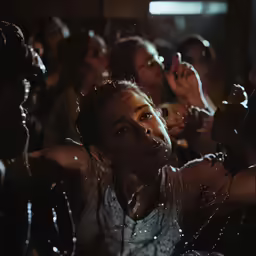 a crowd of people that are standing in the dark