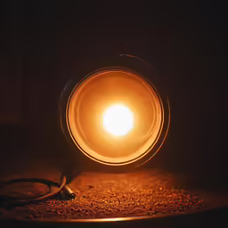 an empty light bulb lit up by a wire