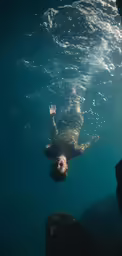 the person is swimming underneath the water in the ocean