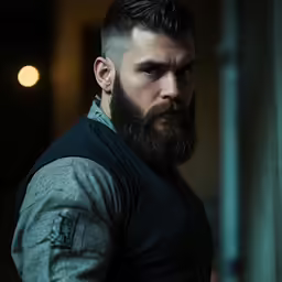 a man with a full beard wearing a gray shirt