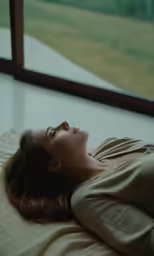 a woman with red hair is laying down