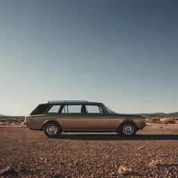 the old station wagon is sitting on the desert