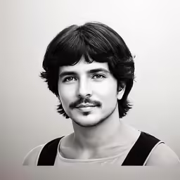 a man with a mustache in black and white