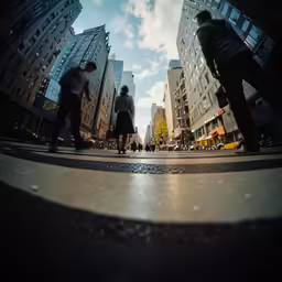 two people wearing dress clothes and walking in a large city