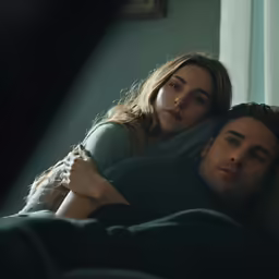 the young man is sleeping on his bed with a young woman
