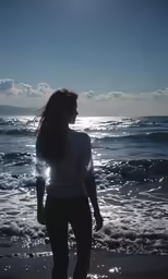 a young woman is walking out of the ocean