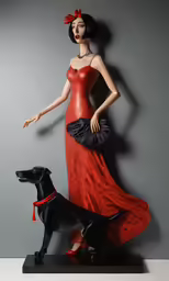 a woman in red stands next to a black dog